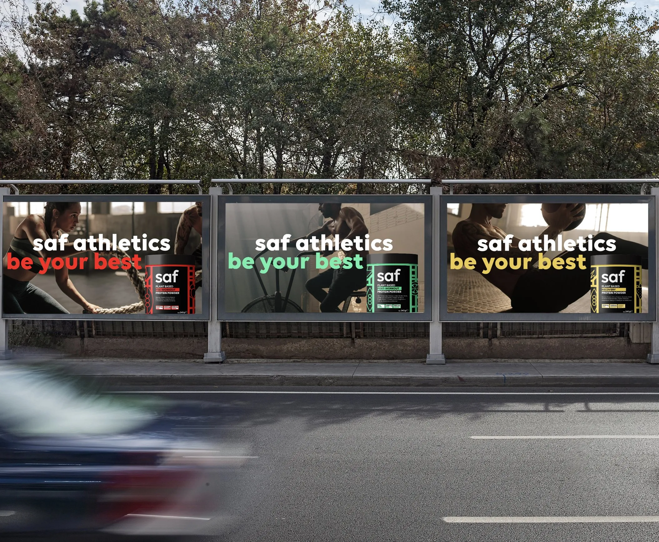 Three 'saf athletics, be your best' posters in a roadside bus shelter as a car passes.