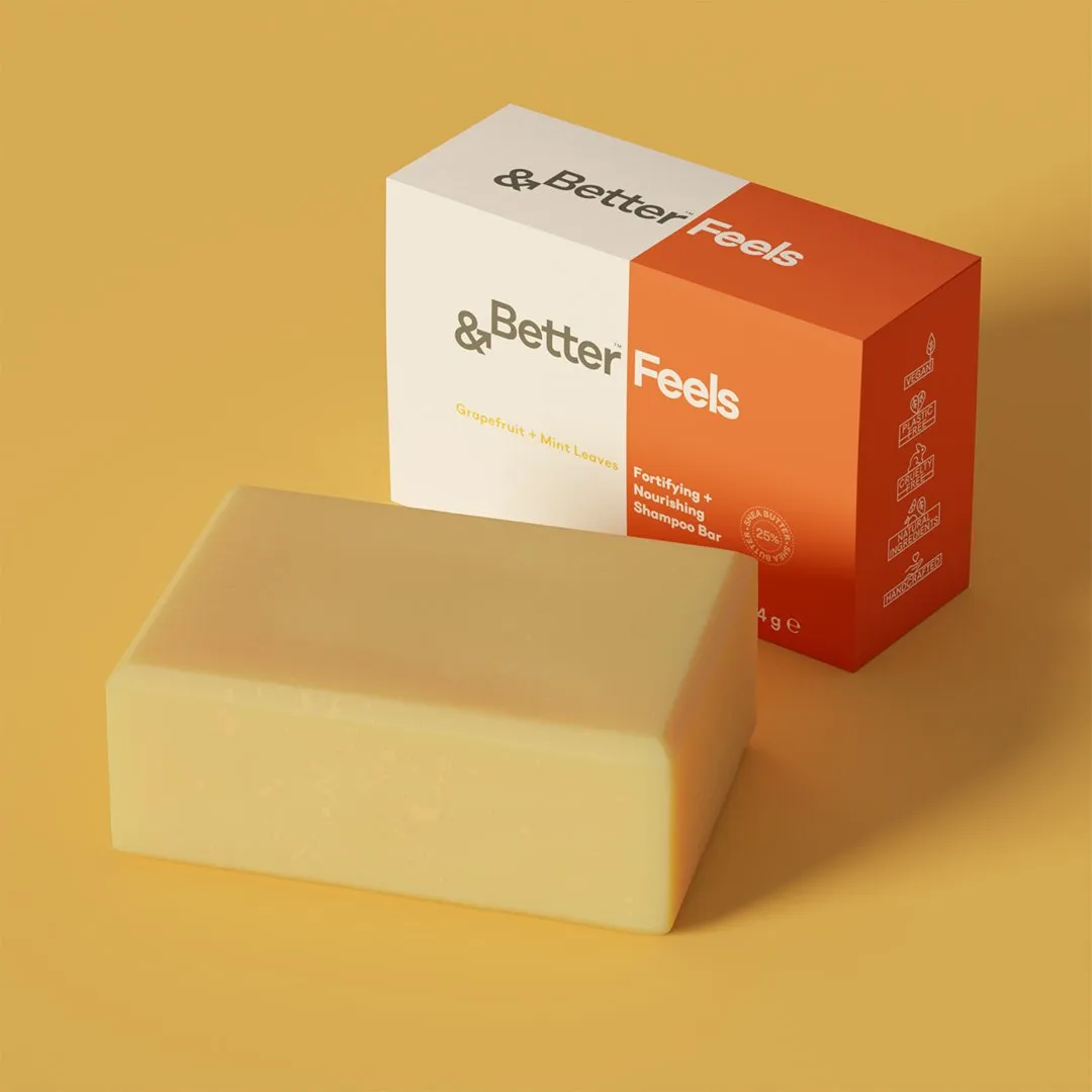 An '&Better Feels' box in orange and cream beside a yellow soap bar on a mustard background.