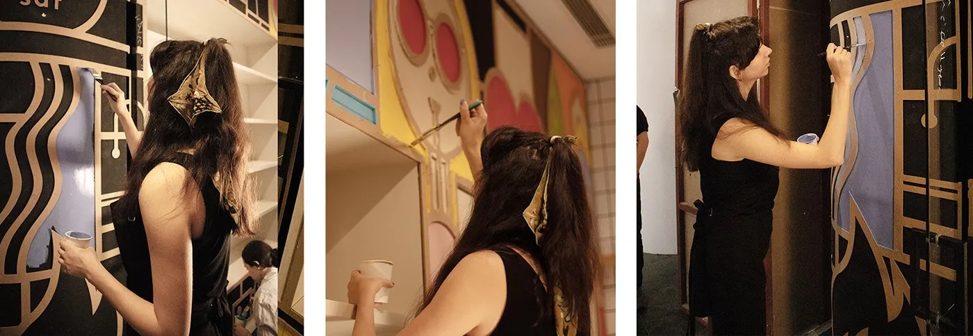Three photographs of the mural being hand-painted on the store walls.