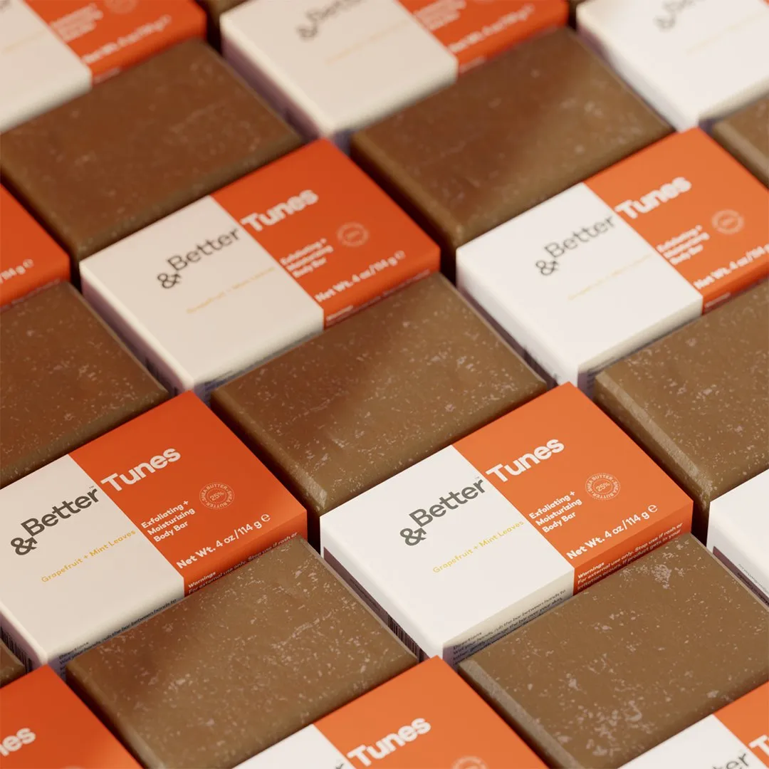 Rows of '&Better Tunes' boxes and brown soap bars in a diagonal pattern.
